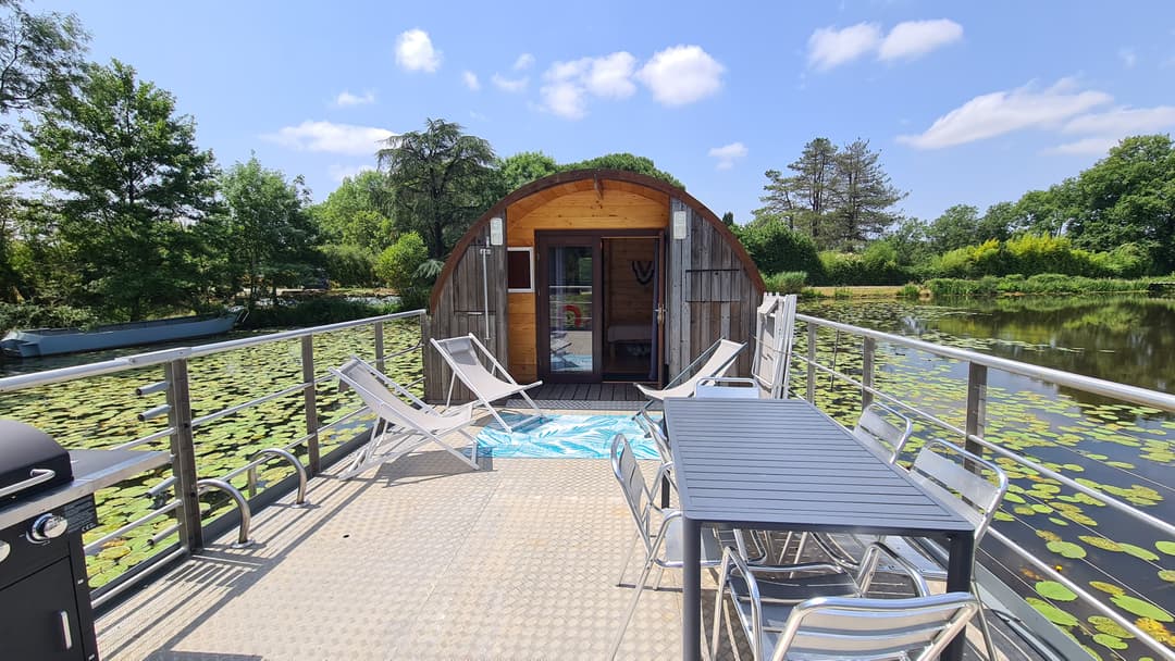 Etang avec bateau cabané au cœur d'un élevage piscicole