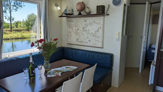 Blue barge rental by a canal with jacuzzi