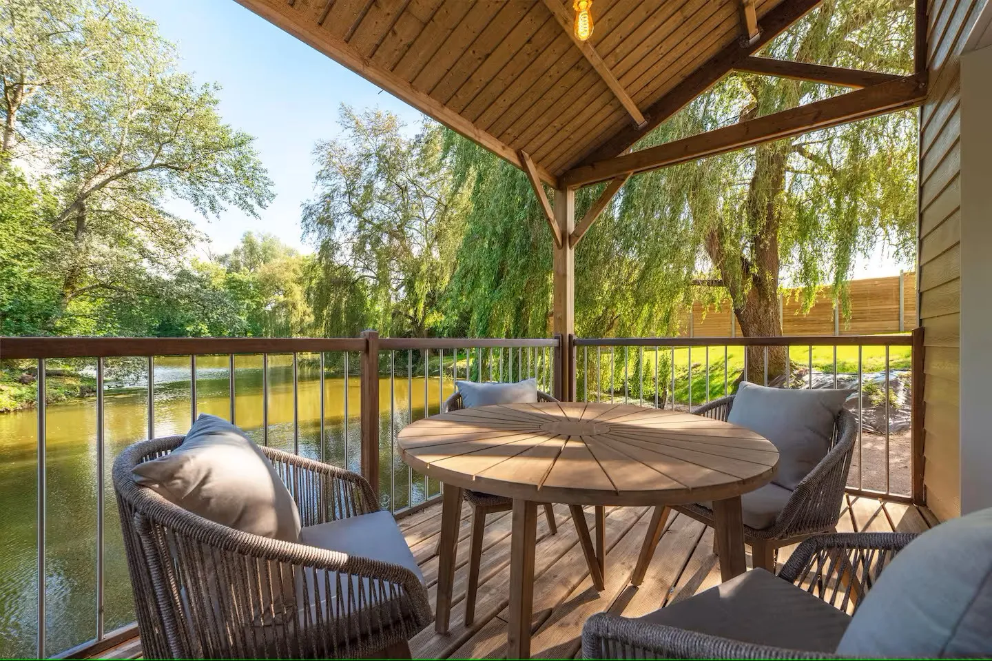 A house hanging on the water of its private pond