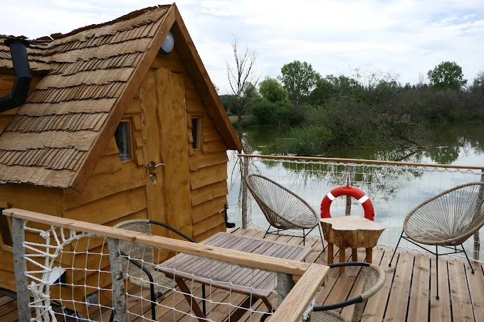 Cabane atypique avec une terrasse ouverte sur l’étang